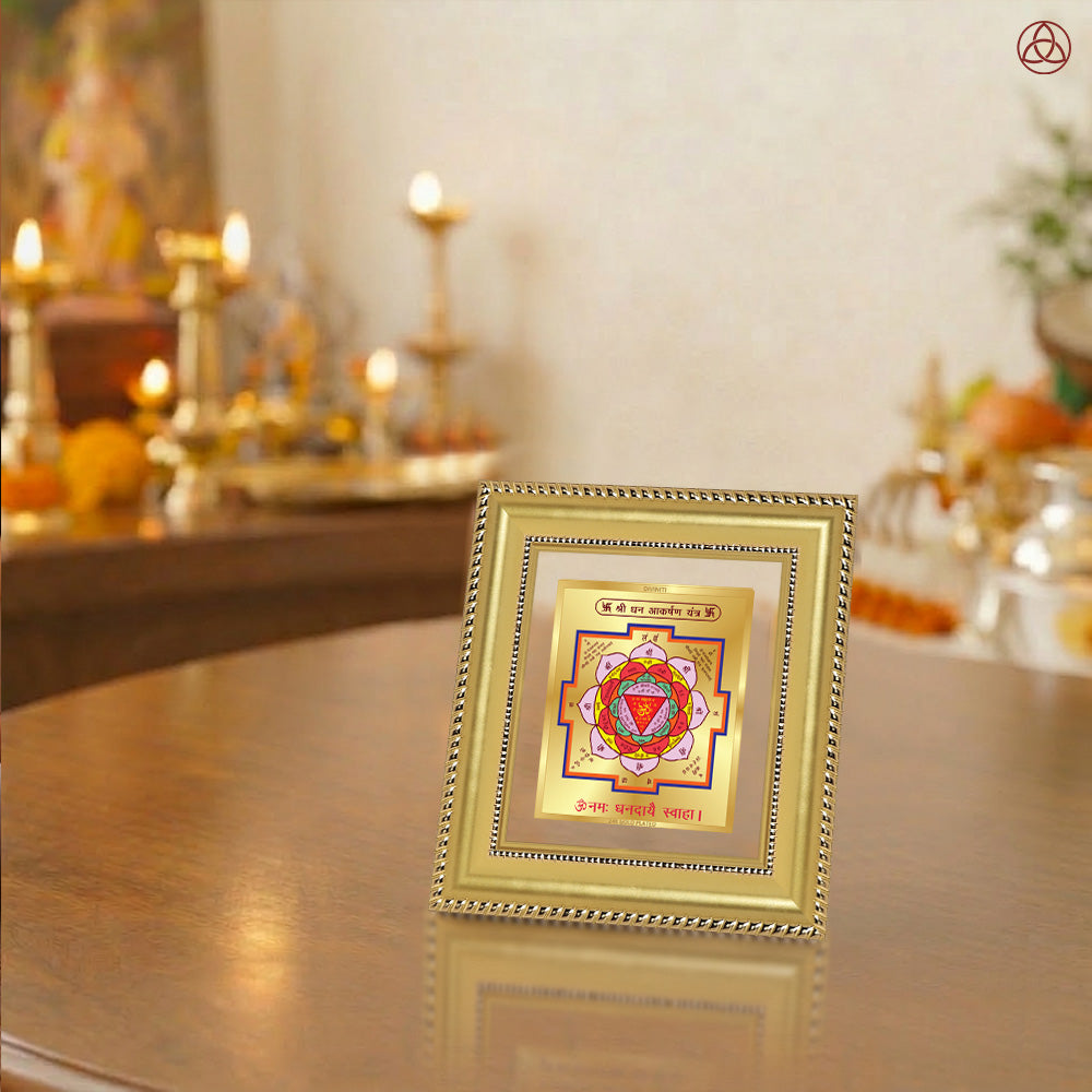 Shri Dhan Akarshan Yantra displayed in a decorative frame on a wooden table, symbolizing planetary energies.