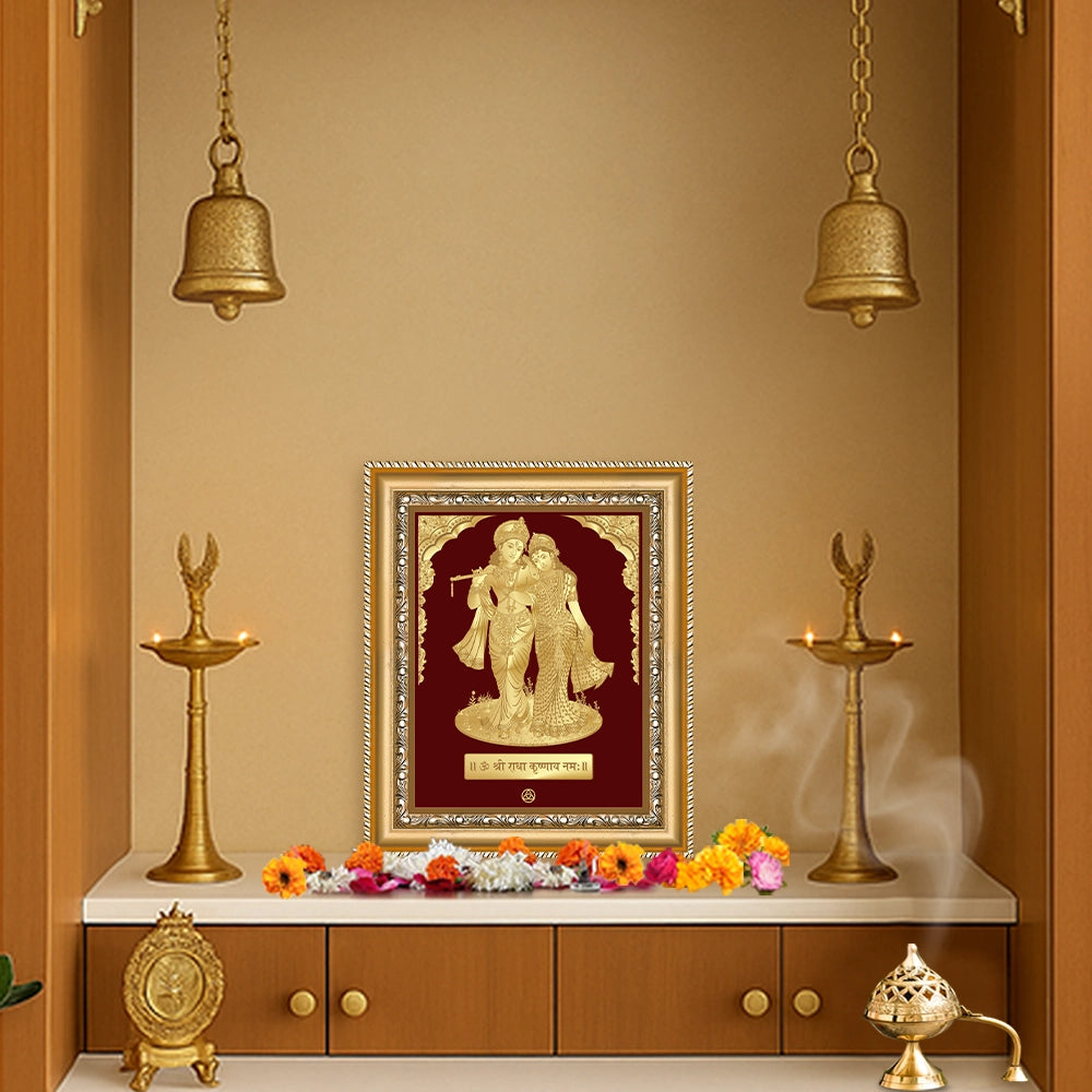 Radha Krishna wall hanging in gold frame, showcasing divine love in a serene temple setting.