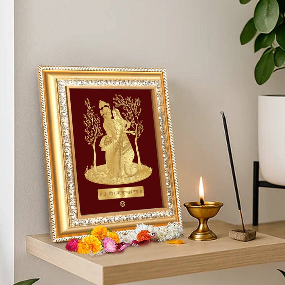 Radha Krishna divine love wall hanging in gold frame, adorned with flowers and incense, showcasing spiritual elegance.