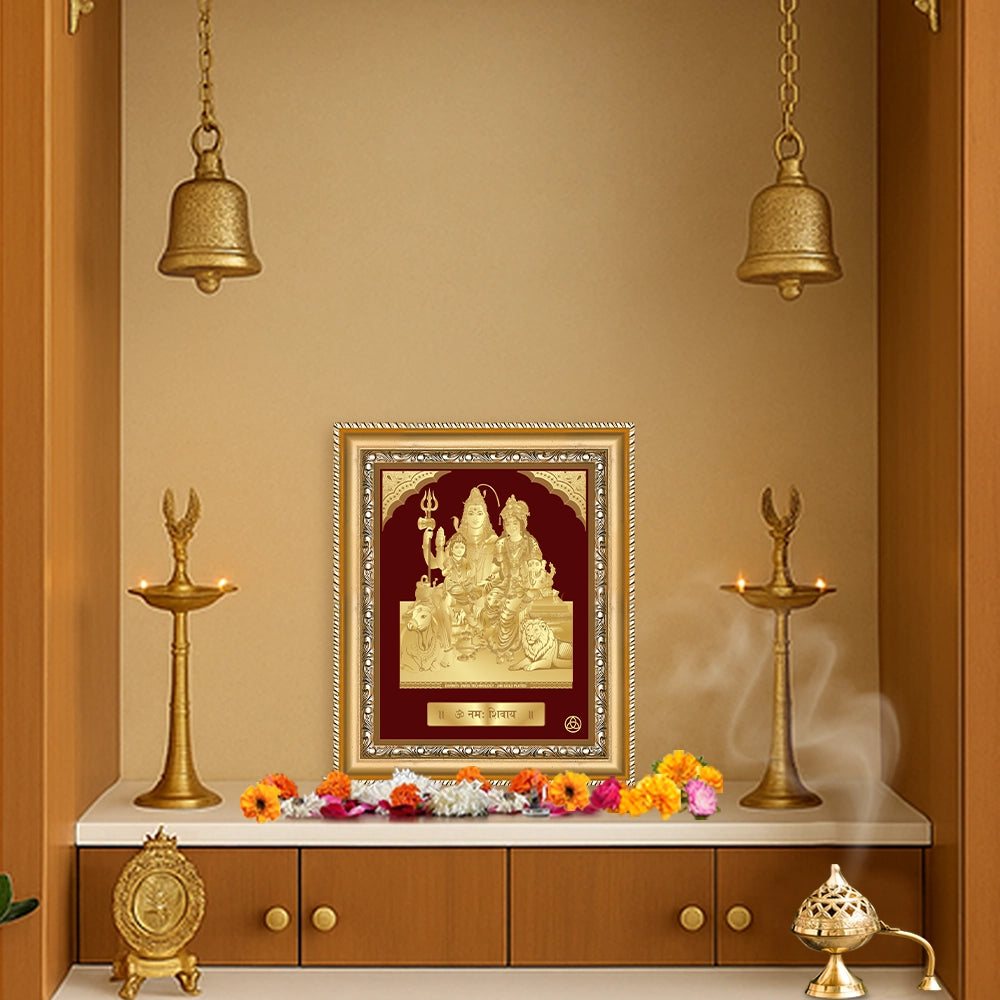 Shiva Parivar gold wall hanging in a spiritual altar setting with decorative elements.