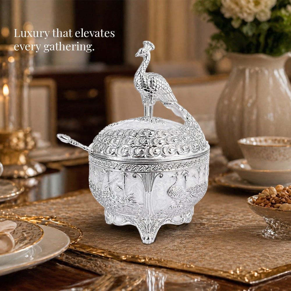 Diviniti German Silver Peacock Sugar Bowl with Spoon displayed elegantly on a dining table, enhancing the luxury of the gathering.