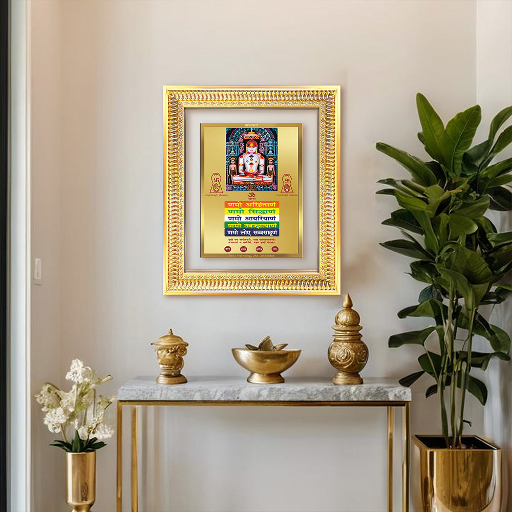 Lord Adinath with Namokar Mantra frame displayed on shelf wall