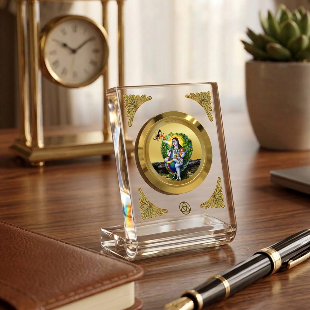 Baba Balak Nath 24K gold plated car dashboard frame elegantly displayed on a wooden desk.