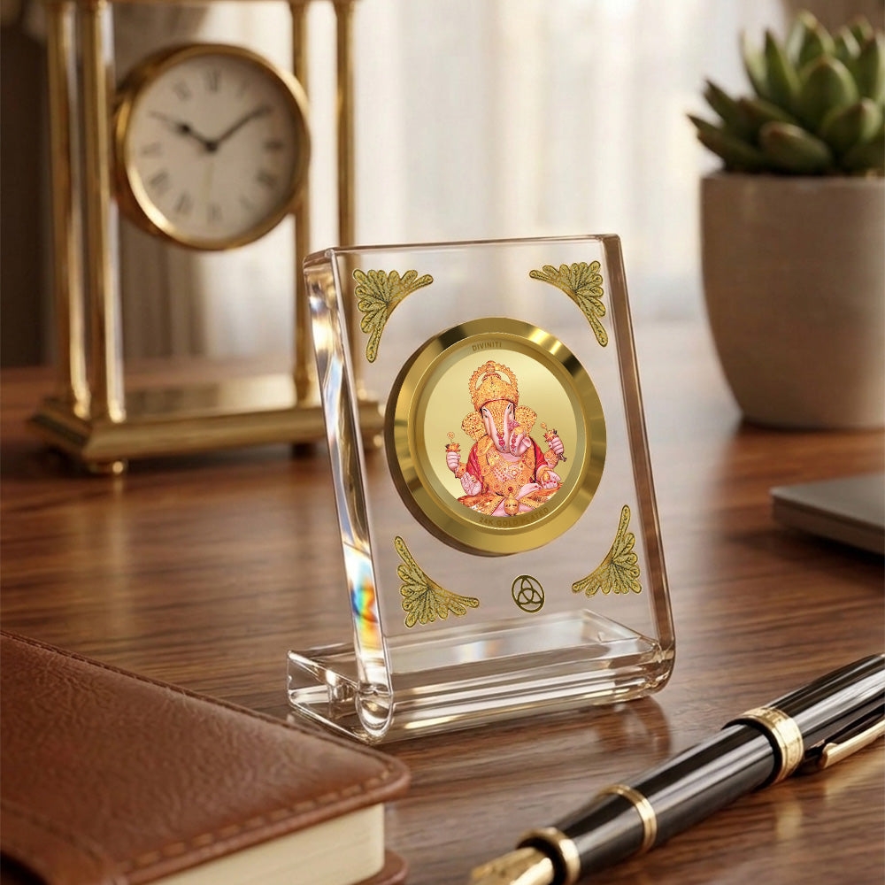Dagadu Ganesha 24K gold plated car dashboard frame elegantly displayed on a wooden desk