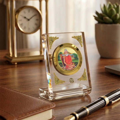 Baba Lokenath 24K gold plated car dashboard frame elegantly displayed on a wooden desk.