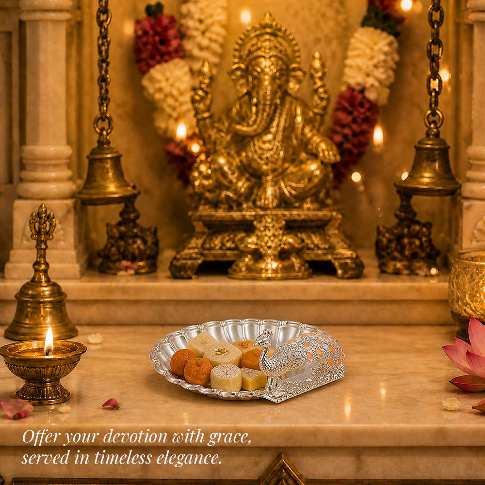 Diviniti Amber Peacock German Silver Dry Fruit Bowl elegantly adorned with sweets, set against a serene religious backdrop.