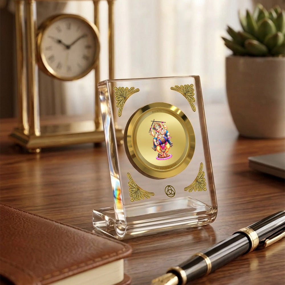 Dancing Ganesha 24K gold plated car dashboard frame elegantly displayed on a wooden desk