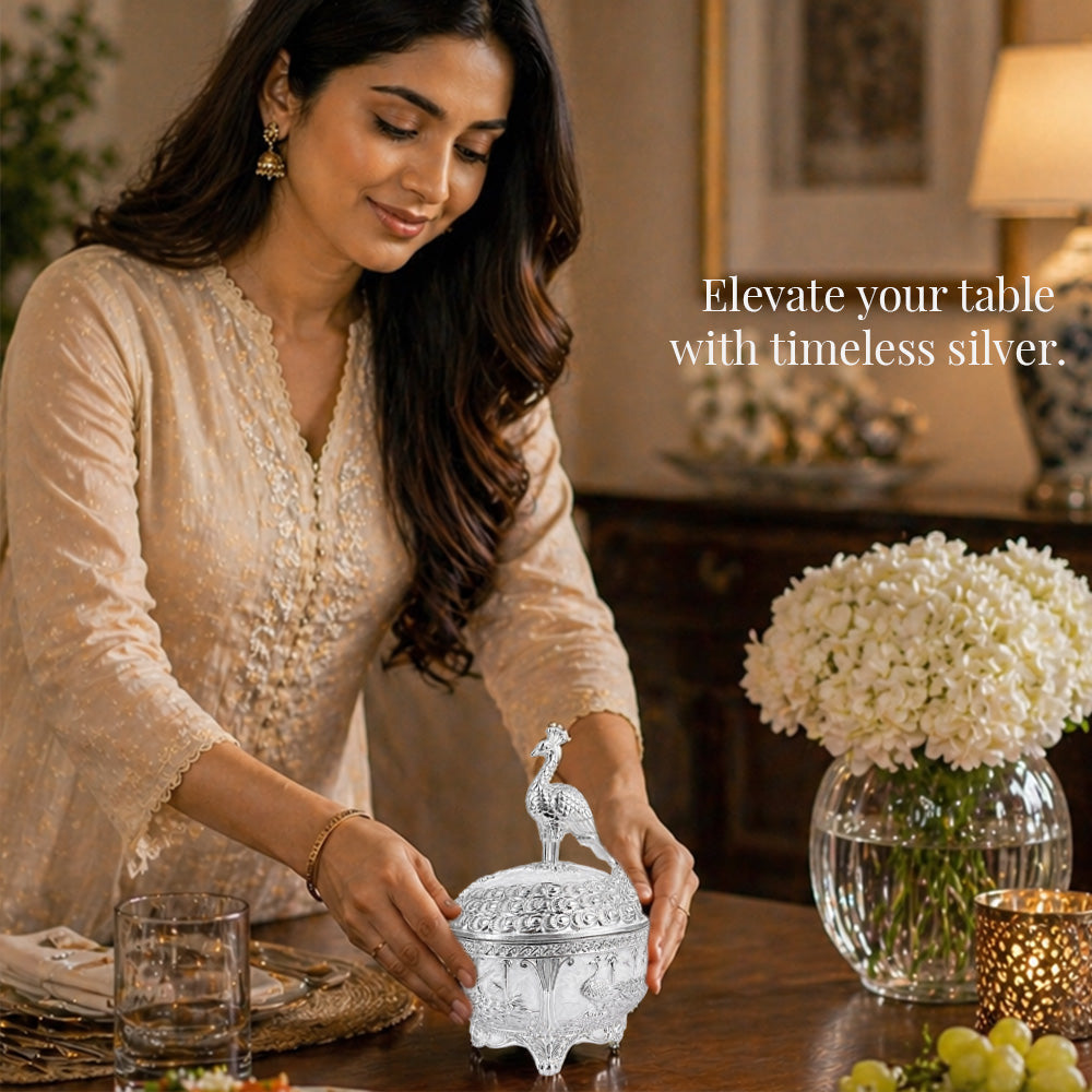 Diviniti German Silver Peacock Sugar Bowl with Spoon elegantly displayed on a dining table, enhancing the atmosphere.