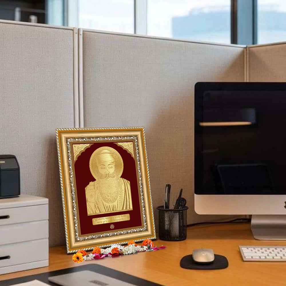 Guru Nanak Dev Ji Photo Frame in 24k gold plated foil displayed on wooden table in office