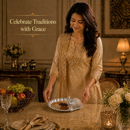 Woman celebrating traditions with a Diviniti Amber Peacock German Silver Dry Fruit Bowl at a festive table.