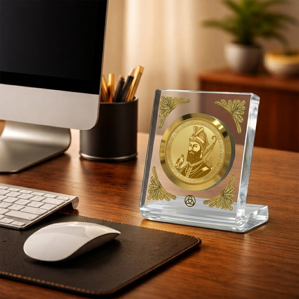 Guru Gobind Singh Ji 24K gold plated frame on a desk with a computer and stationery, radiating elegance.
