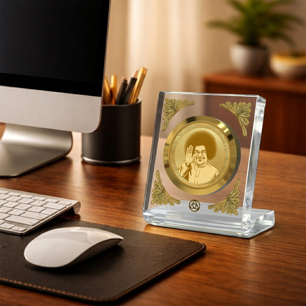 Satya Sai Baba 24K gold plated frame on a desk, enhancing workspace aesthetics with divine elegance.