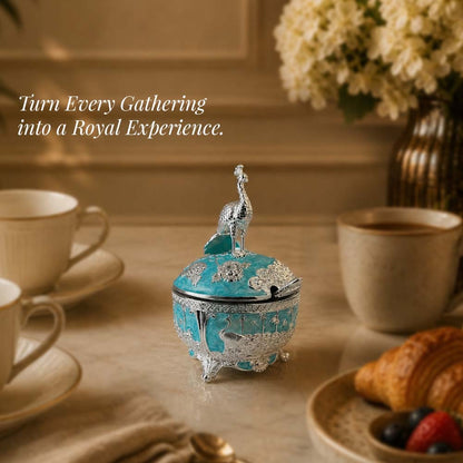 Diviniti German Silver Peacock Sugar Bowl with Spoon in turquoise blue finish on a dining table.
