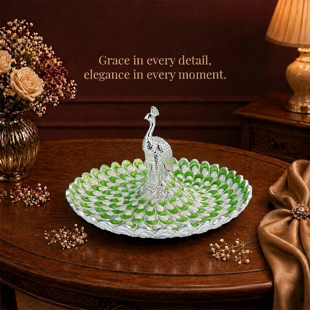 Diviniti Sage Green Peacock German Silver Platter displayed elegantly on a wooden table with decorative flowers.