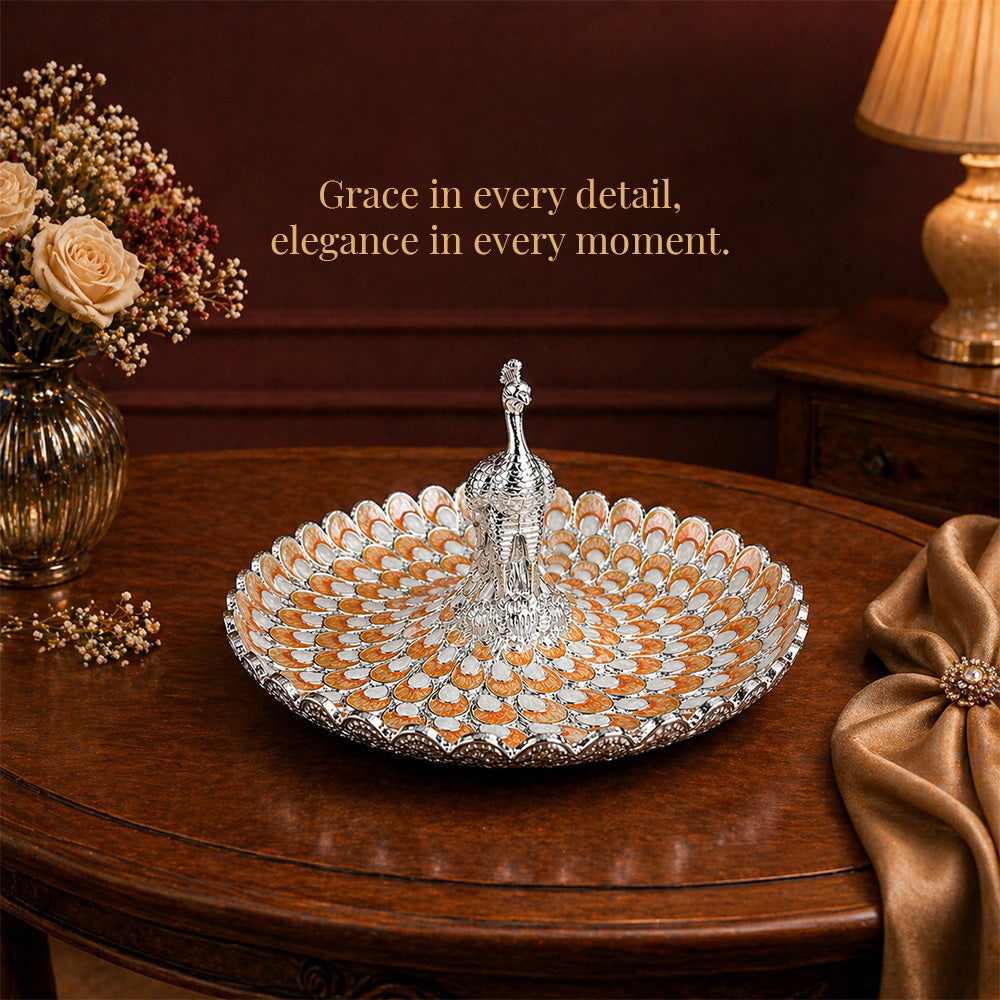 Diviniti Amber Peacock German Silver Platter with Gift Box displayed elegantly on a wooden table with flowers.