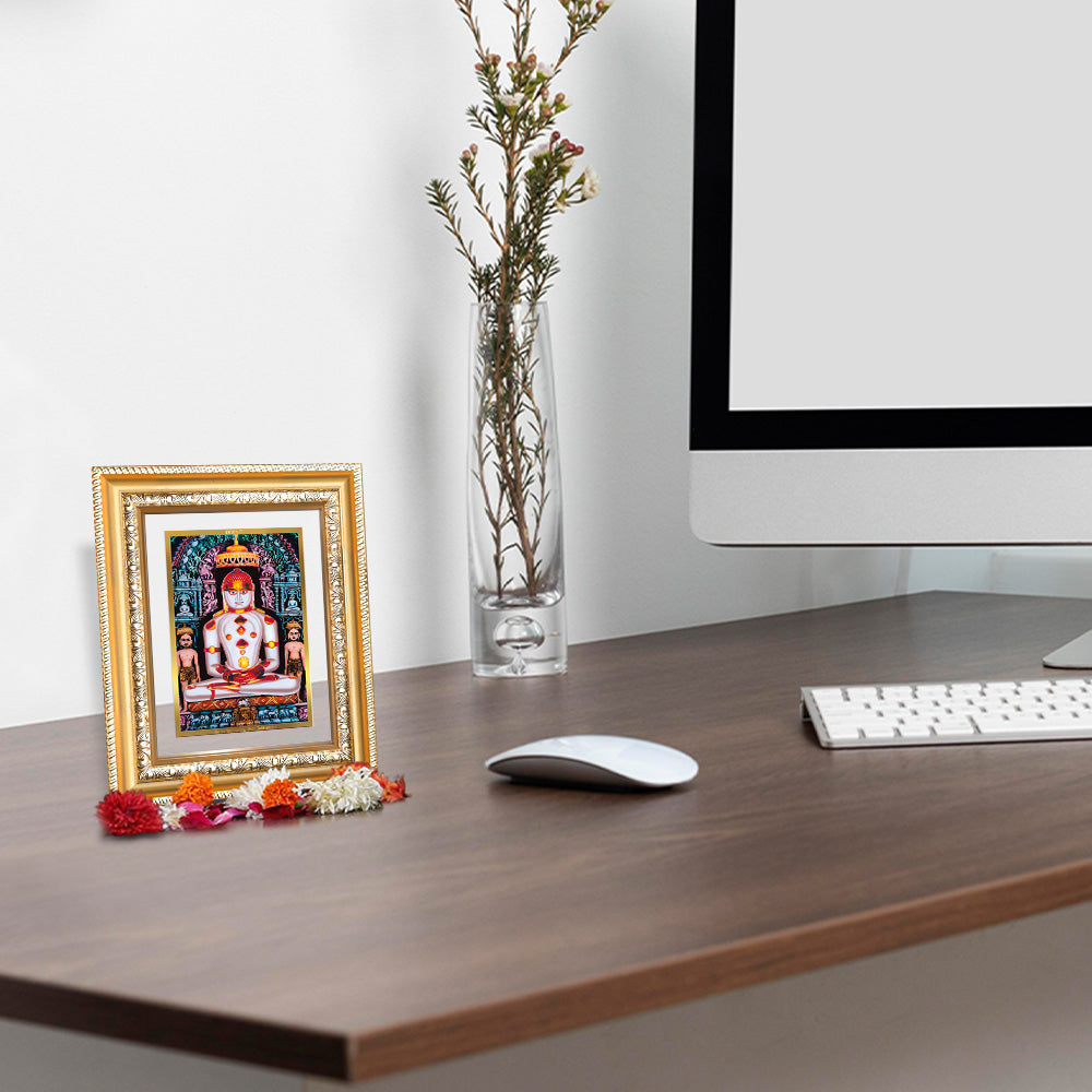 Adinath 24K Gold Plated Wall and Tabletop Photo Frame in 24K Gold Plated Foil on a desk.