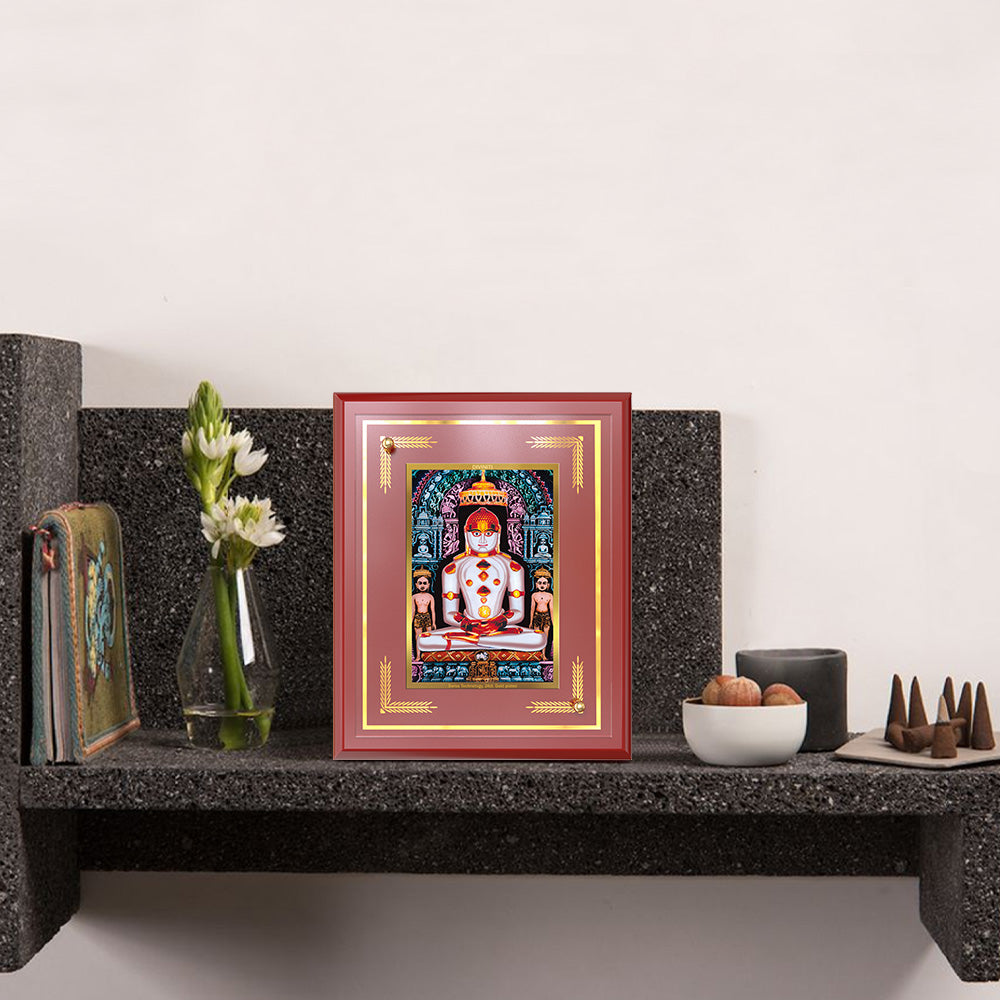 Bhagwan Adinath Tabletop Photo Frame displayed on wooden shelf 
