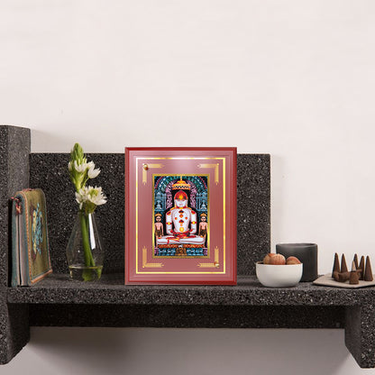 Bhagwan Adinath Tabletop Photo Frame displayed on wooden shelf 