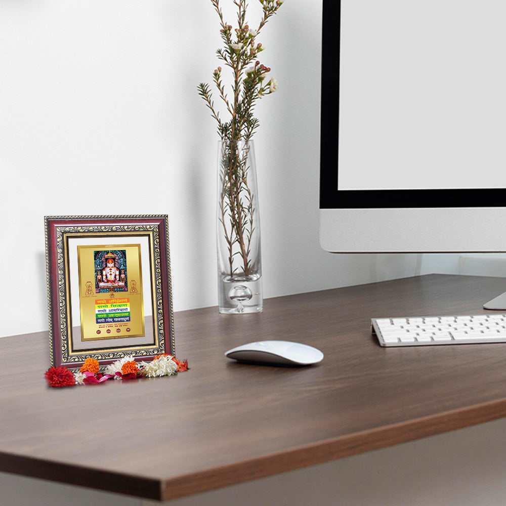 Lord Adinath with Namokar Mantra photo frame on a desk with flowers and computer, 24K gold plated design.