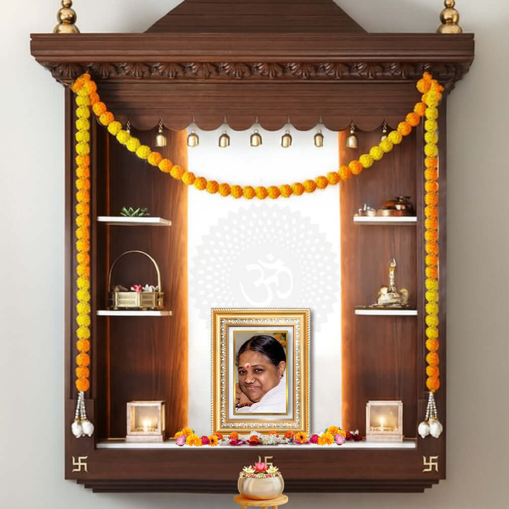 Mata Amritanandamayi photo frame in 24K Gold Plated Foil displayed on a beautifully decorated wooden shelf.