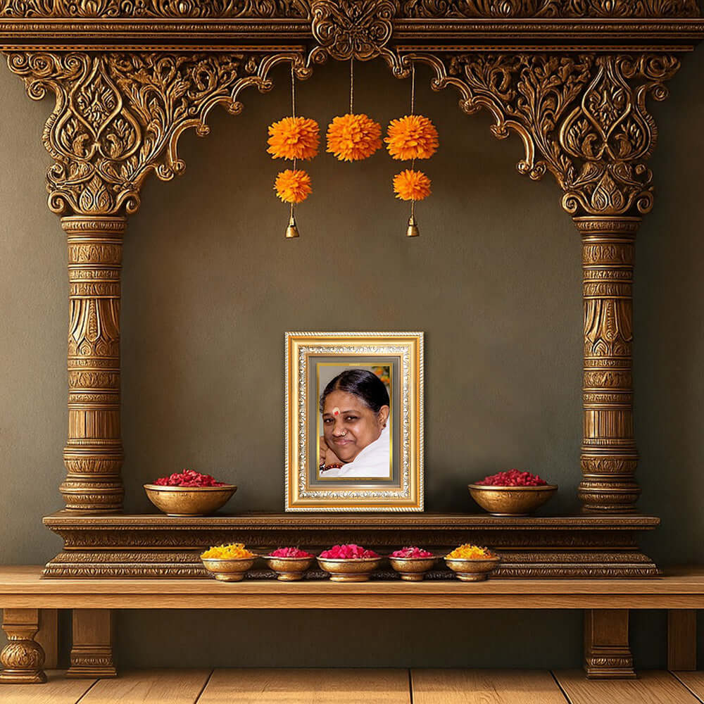 Mata Amritanandamayi photo frame in a decorative setting with flowers and a traditional Indian altar.