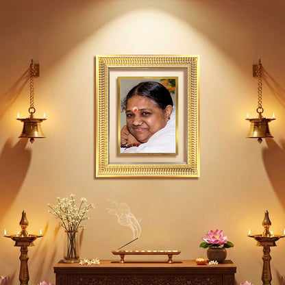 Mata Amritanandamayi framed in 24K gold-plated foil, displayed in a serene spiritual setting.