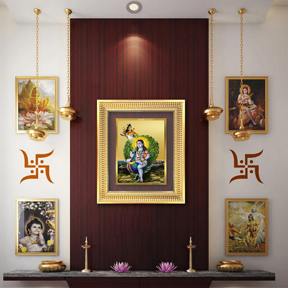 Baba Balak Nath Paunahari framed art in a spiritual wall setup with golden decor and traditional Indian paintings.