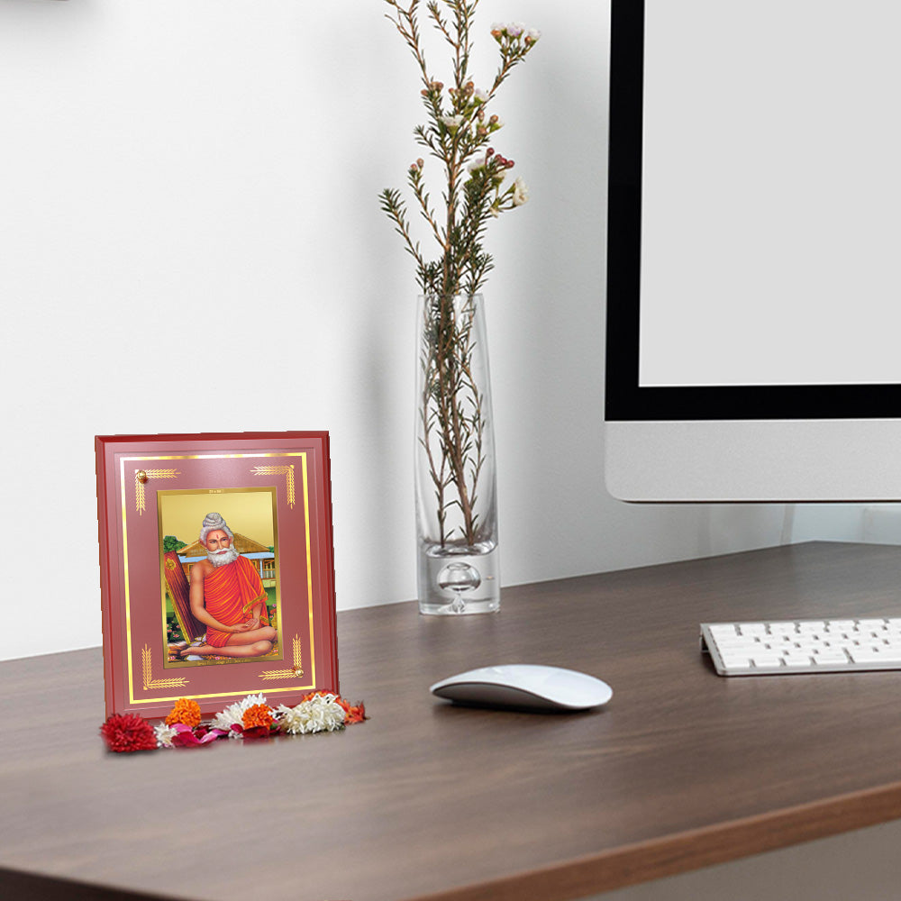 Baba Lokenath Wall Frame in 24k gold plated foil displayed on wooden table