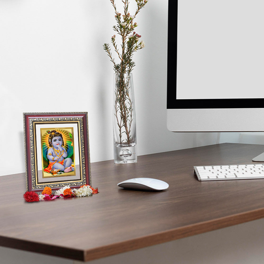 Bal Gopal photo frame in 24k gold plated foil displayed on wooden table