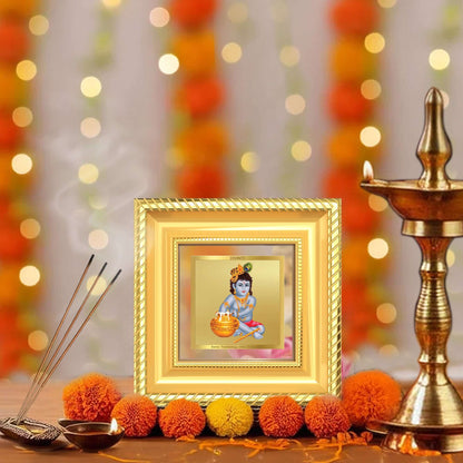 Makhan Gopal Baby Krishna Tabletop Frame displayed with brass diyas, incense holder, and marigold flowers in a peaceful home prayer corner