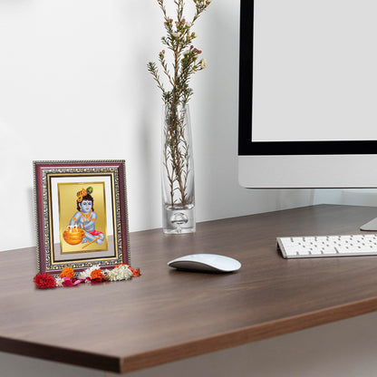 Bal Makan Gopal Tabletop Photo Frame in 24K Gold Plated Foil displayed on wooden table