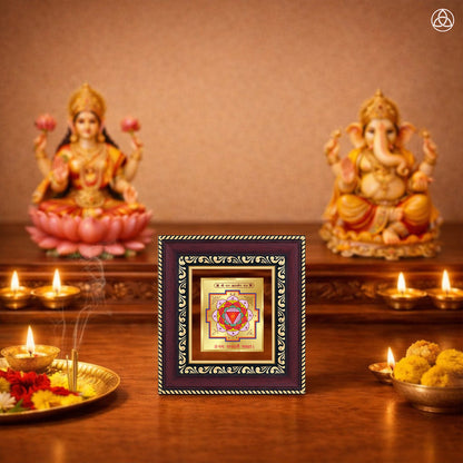 Shri Dhan Akarshan Yantra displayed on a decorated altar with candles and idols of Hindu deities for spiritual harmony.