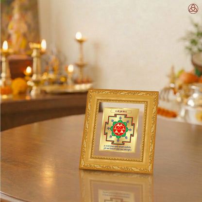 Durga Yantra framed in 24K gold-plated foil on a wooden table with traditional decor.
