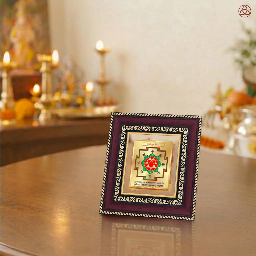 Durga Yantra framed in 24K gold-plated foil on a wooden table with traditional decor.