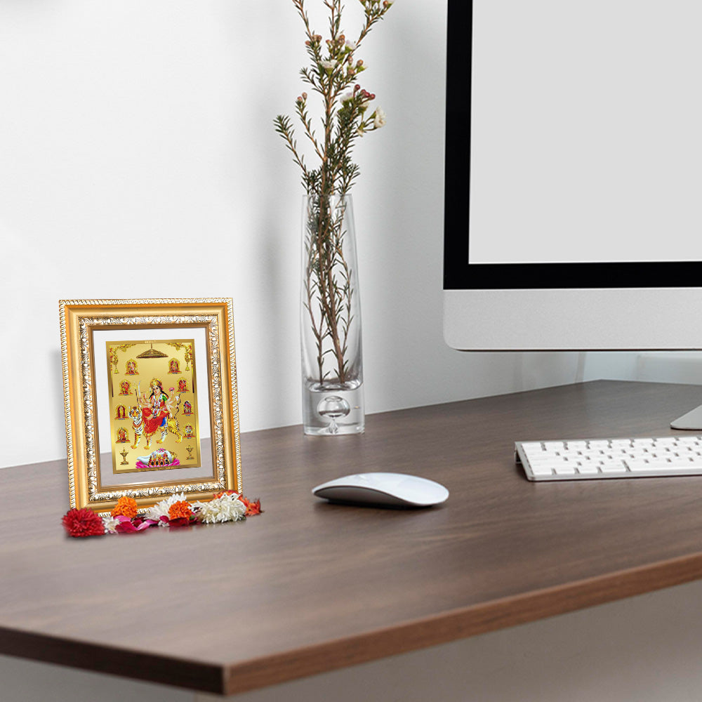 Nav Durga photo frame framed in 24K gold, displayed in a beautifully decorated wooden wall shrine.