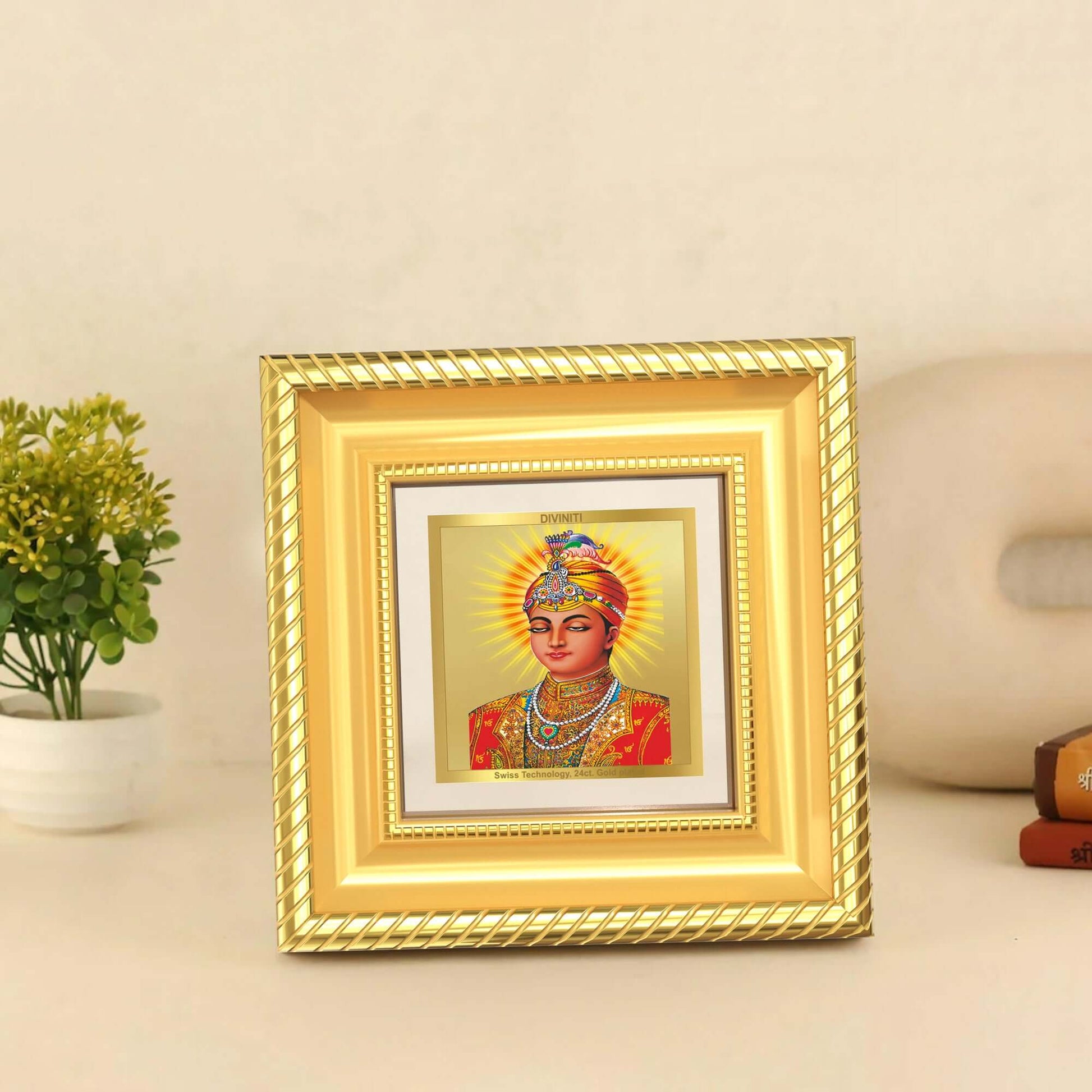 Guru Harkrishan Sahib Ji in 24K Gold Plated Foil displayed on wooden table