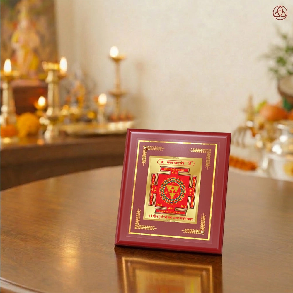 Kanak Dhara Yantra framed artwork with Goddess Lakshmi and Ganesha statues in a spiritual setting.