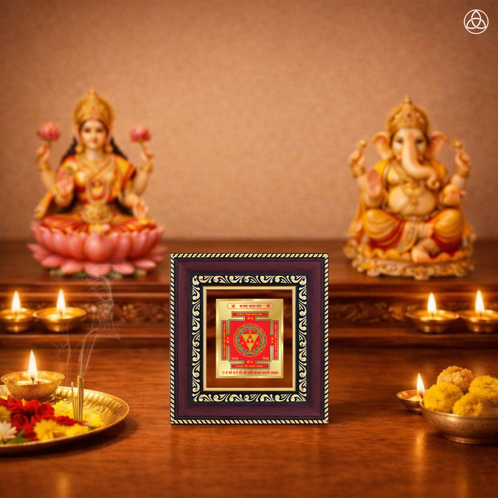 Kanak Dhara Yantra framed artwork with Goddess Lakshmi and Ganesha statues in a spiritual setting.