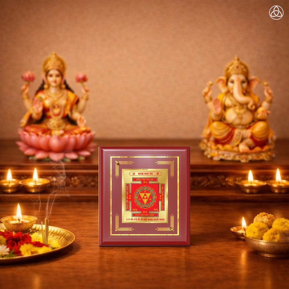 Kanak Dhara Yantra framed on a wooden table with a decorative background featuring warm lighting and spiritual elements.