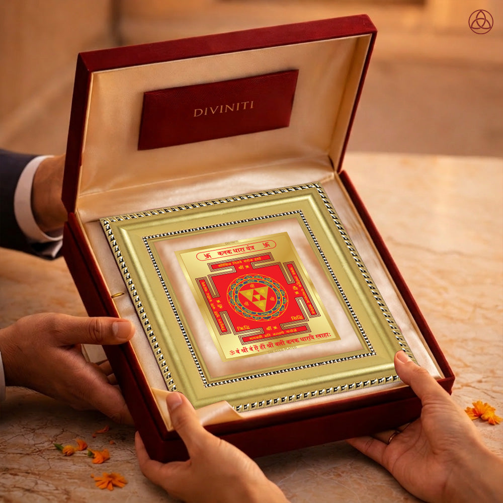 Kanak Dhara Yantra in a luxurious presentation box held by two hands, symbolizing prosperity and abundance.