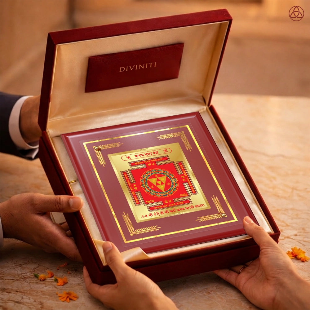 Kanak Dhara Yantra in a luxurious presentation box held by two hands, symbolizing prosperity and abundance.