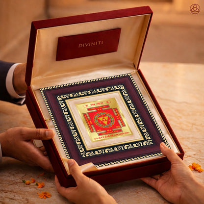 Kanak Dhara Yantra in a luxurious presentation box held by two hands, symbolizing prosperity and abundance.