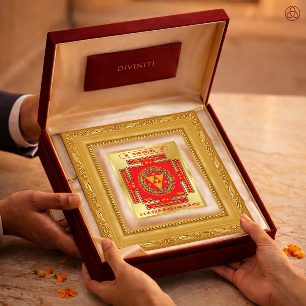 Kanak Dhara Yantra in a luxurious presentation box held by two hands, symbolizing prosperity and abundance.