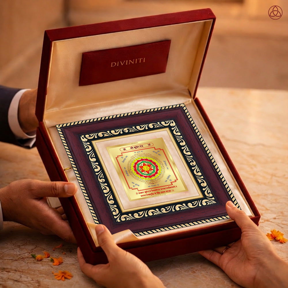 Kuber Yantra in a luxurious frame held in hands, symbolizing wealth and prosperity, beautifully crafted in 24K gold-plated foil.
