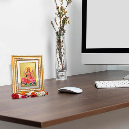 Goddess Lakshmi wall and tabletop photo frame in a stylish home office setting with flowers and computer.