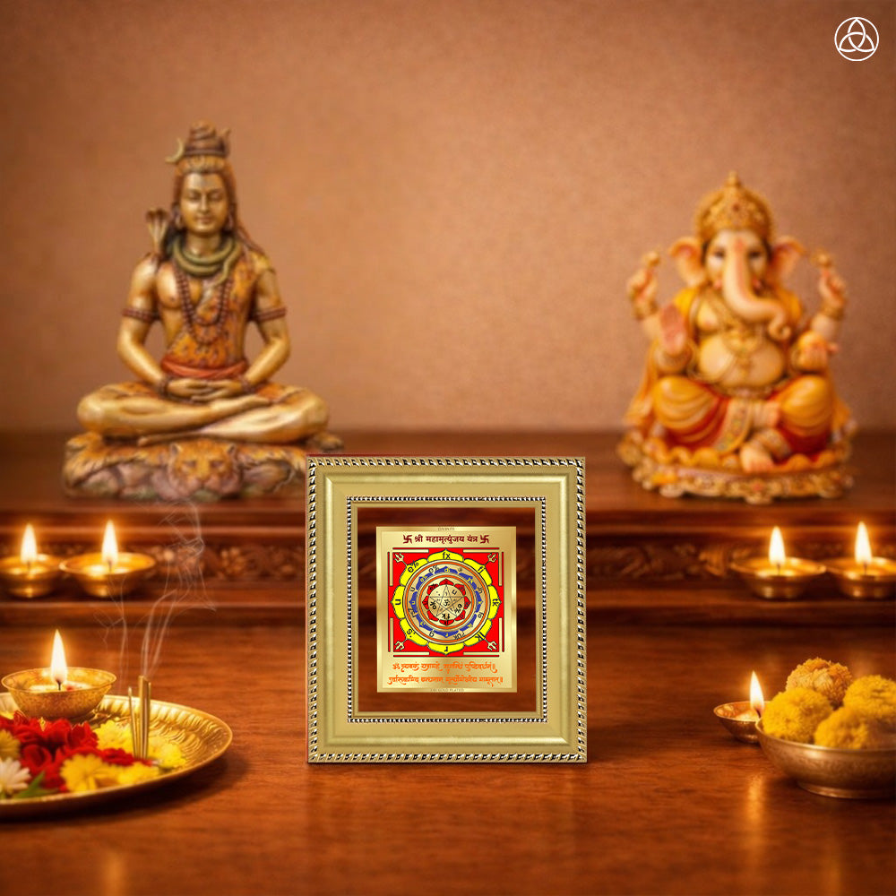 Maha Mrityunjay Yantra displayed on a decorated altar with candles and idols of Hindu deities for spiritual harmony.