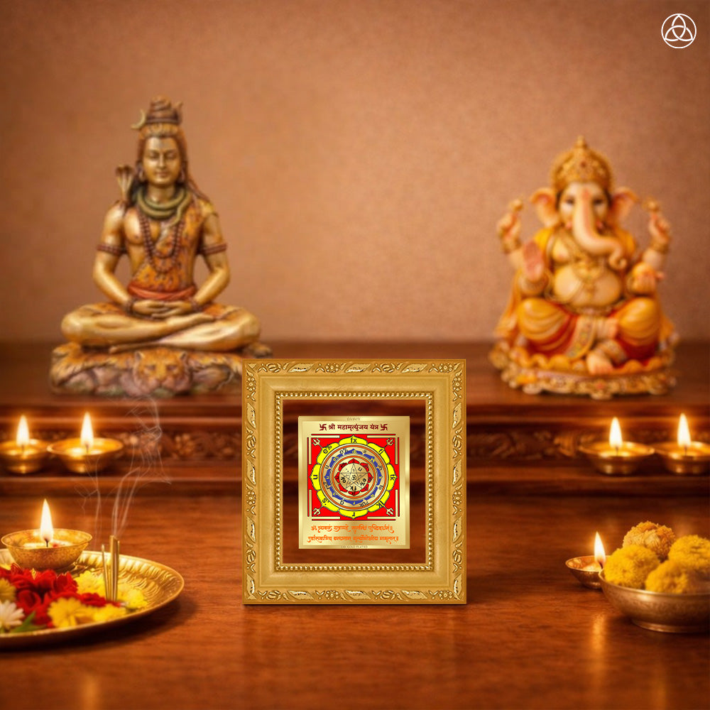 Maha Mrityunjay Yantra displayed on a decorated altar with candles and idols of Hindu deities for spiritual harmony.
