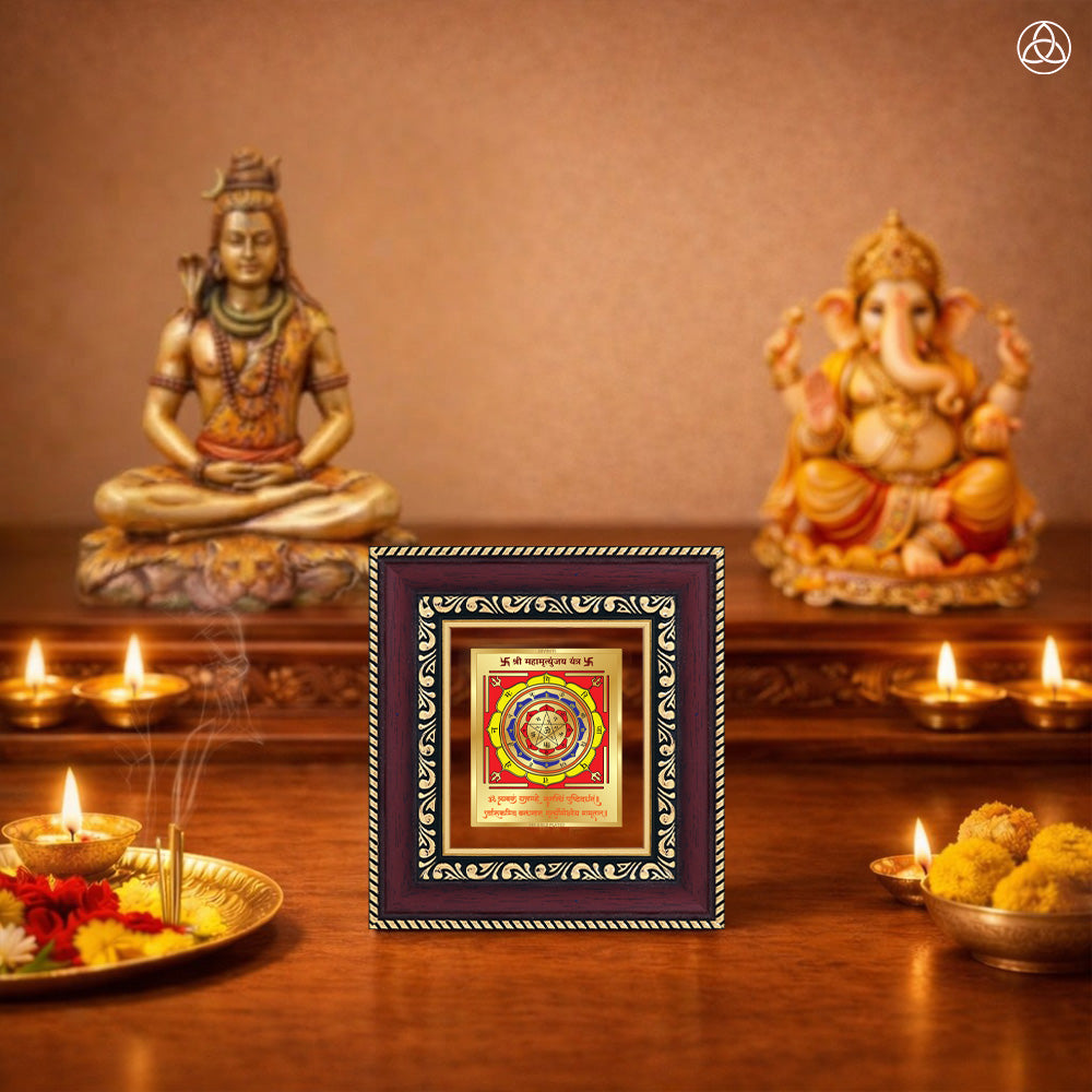 Maha Mrityunjay Yantra framed artwork in a spiritual setting with Lord Shiva and Ganesh statues.
