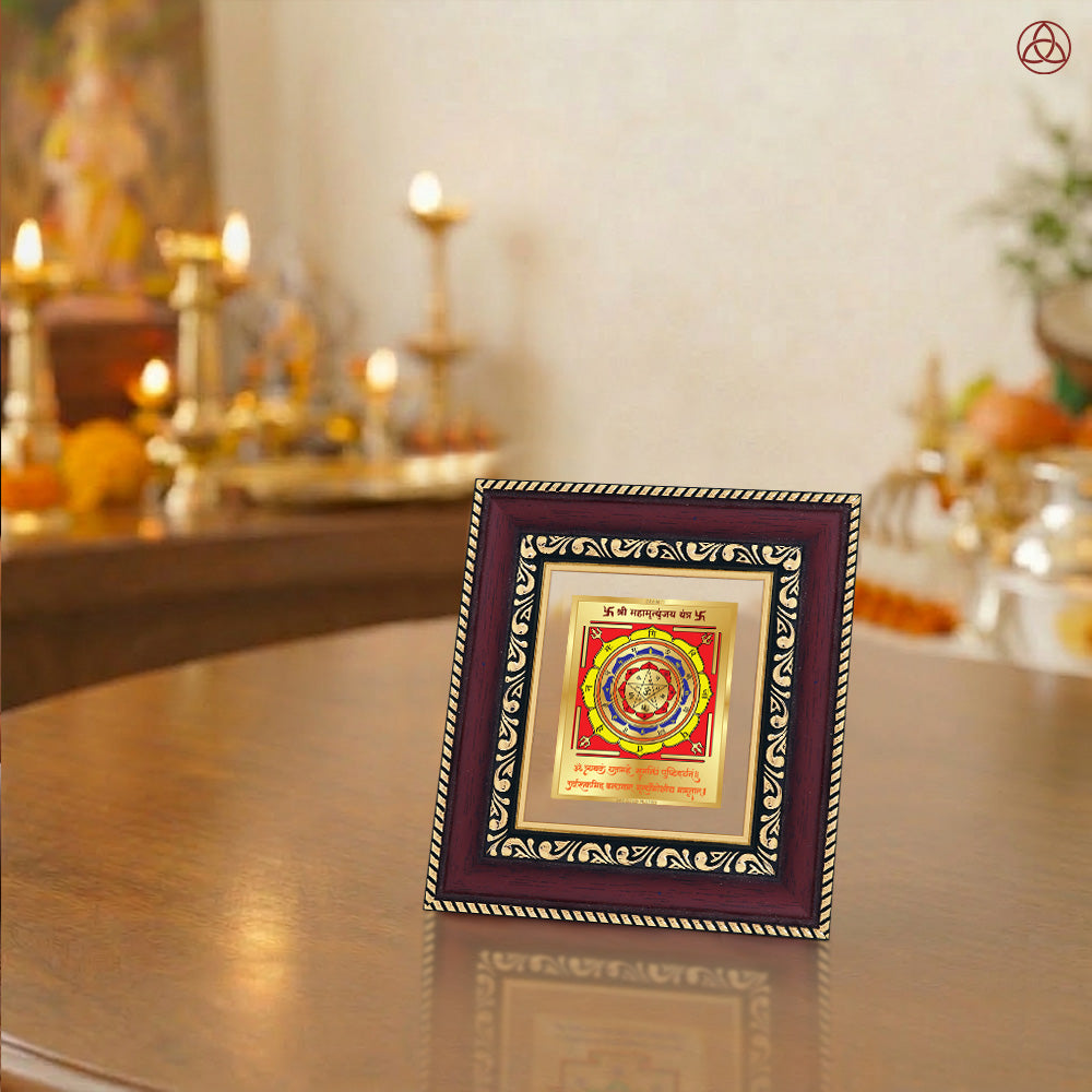 Maha Mrityunjay Yantra beautifully displayed in an ornate frame on a decorative table setting.