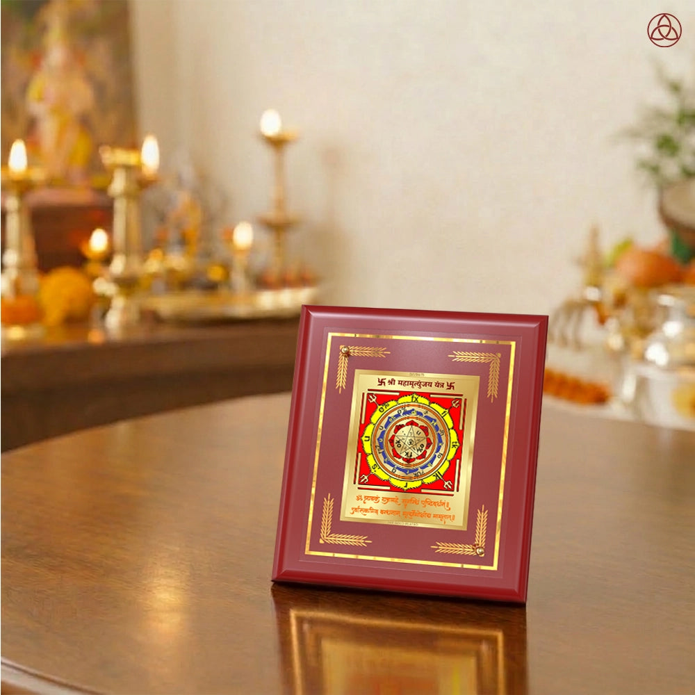 Maha Mrityunjay Yantra displayed on a decorated altar with candles and idols of Hindu deities for spiritual harmony.